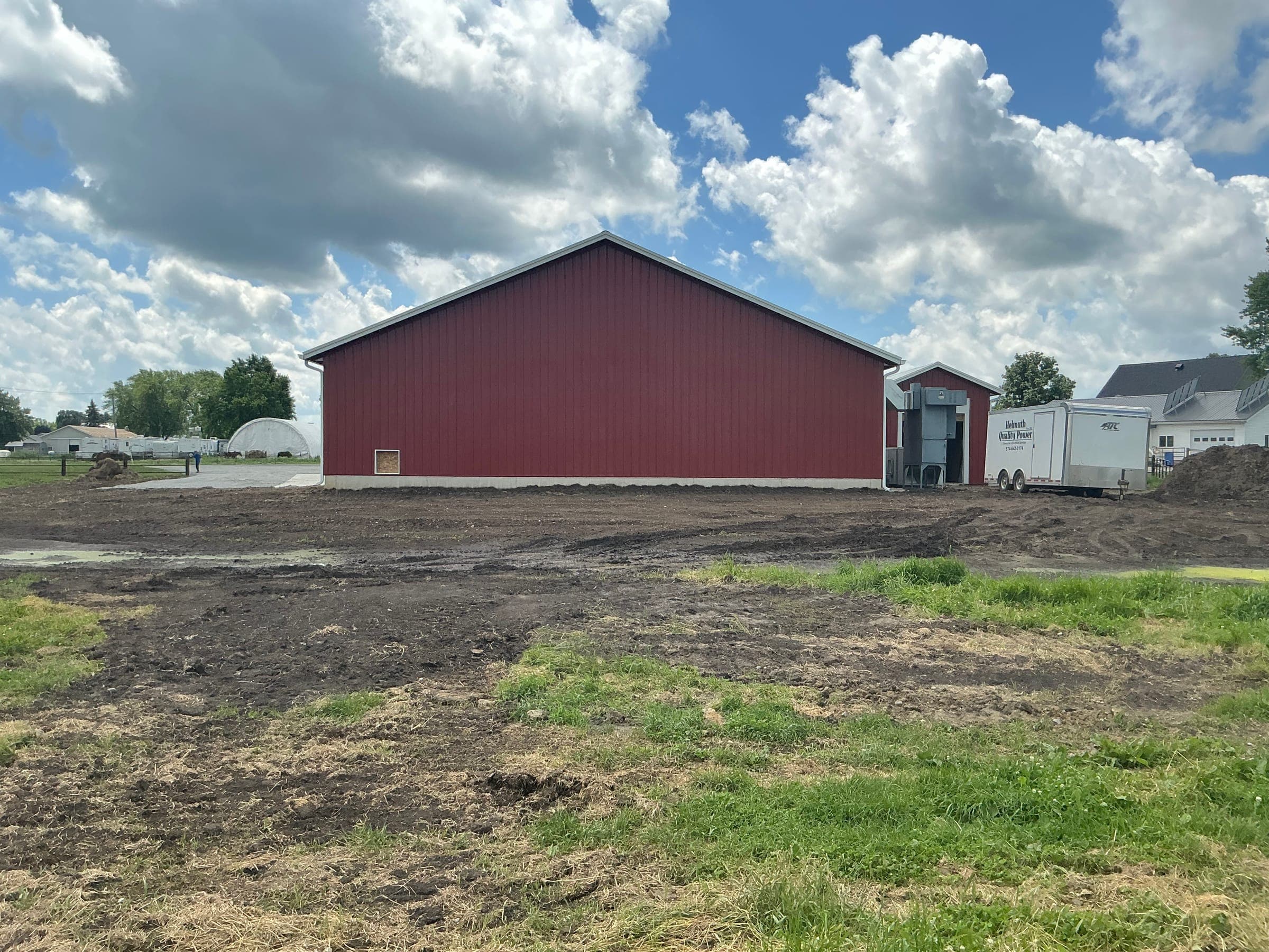 Side view of large red post-frame commercial barn built by Starlite Builders in Indiana