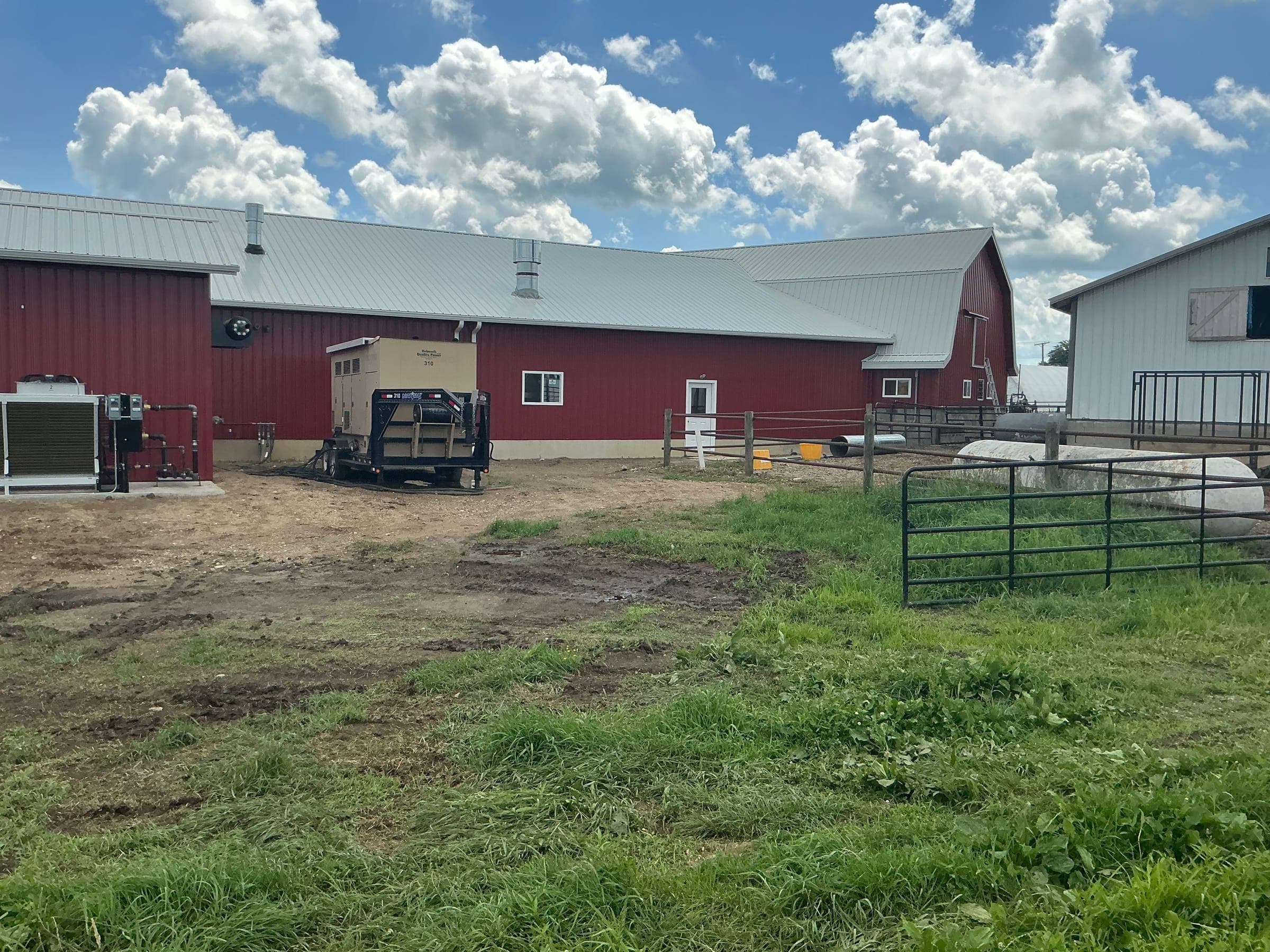 Red barn complex with livestock pens and classic gambrel roof barn built by Starlite Builders in Northern Indiana