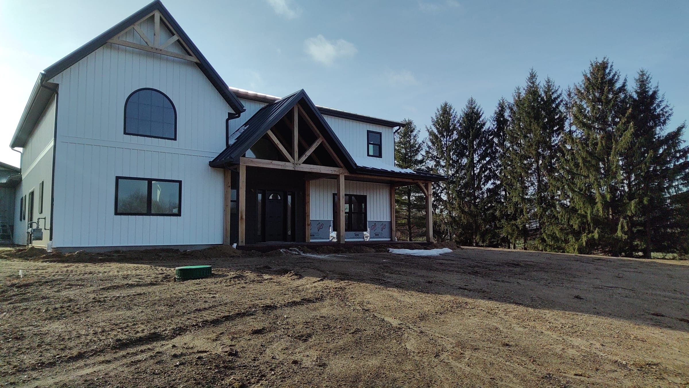 Wide angle of custom modern farmhouse with board and batten siding in Northern Indiana